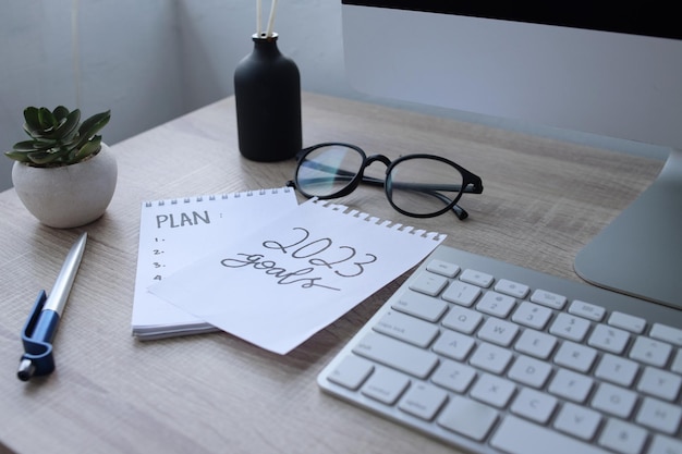 New year plan 2023 on desk. Resolutions, plan, goals, action, checklist, idea concept.