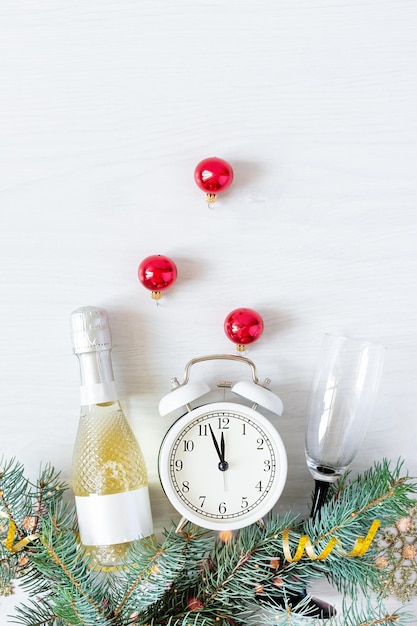 New Year's background with champagne bottle fir branches and Christmas decorations