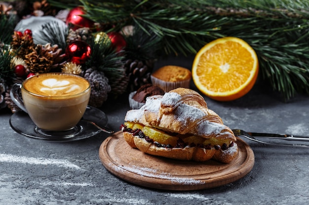 New Year's breakfast with croissants. New Year's croissant with chocolate and baked orange.