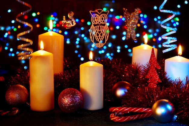 New Year's Christmas table with decor. Candles, clocks and Christmas toys with lights