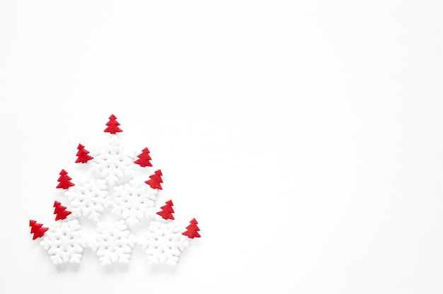 New Year's composition. Abstract Christmas tree made of snowflakes on a white background. Isolation with copy space.