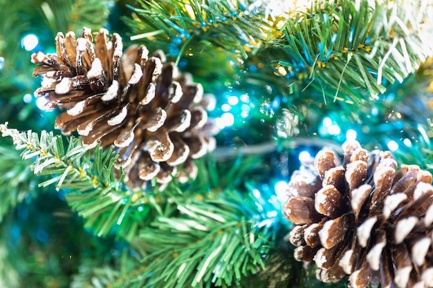 New Year's composition Christmas background top view on white background Christmas or New Year blurred snow background with festive fir tree and pine cones selective focus