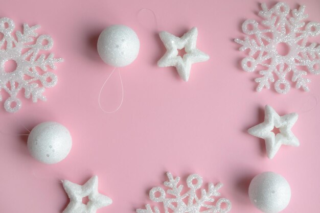 New Year's composition Christmas pink and white decorations on a pastel pink background with space for text Layout of a postcard poster