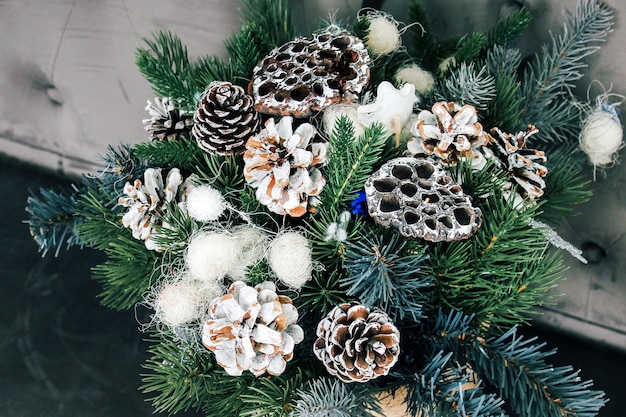 New Year's composition of dried lotus flowers, cones and spruce branches. DIY bouquet for Christmas.