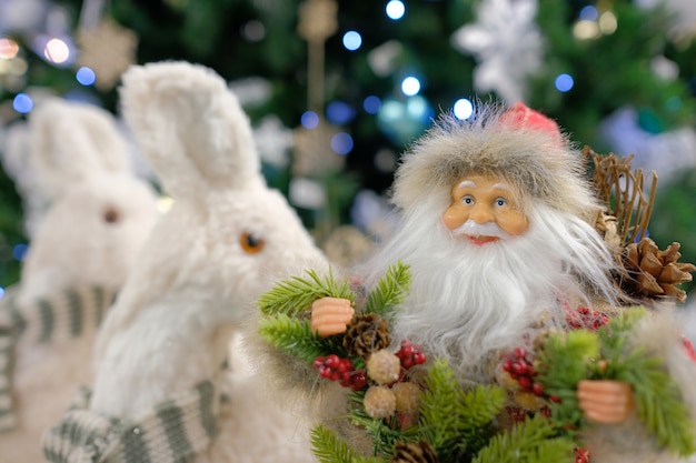 New Year's decor Santa Claus close-up on the background of the Christmas tree. Christmas toy Santa Claus.