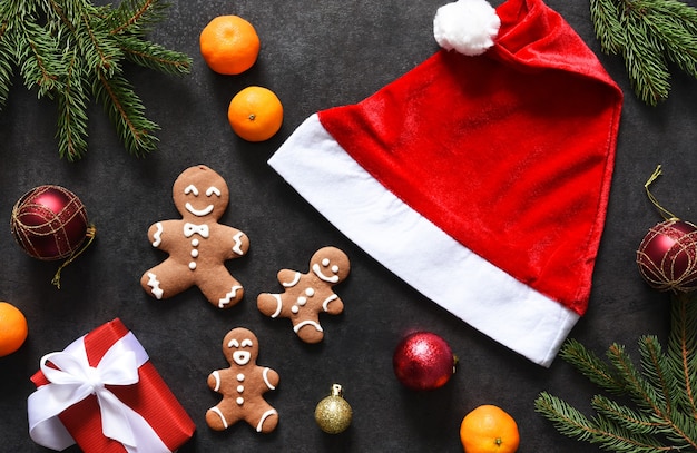 New Year's decoration with Santa's hat, tangerines and gingerbread