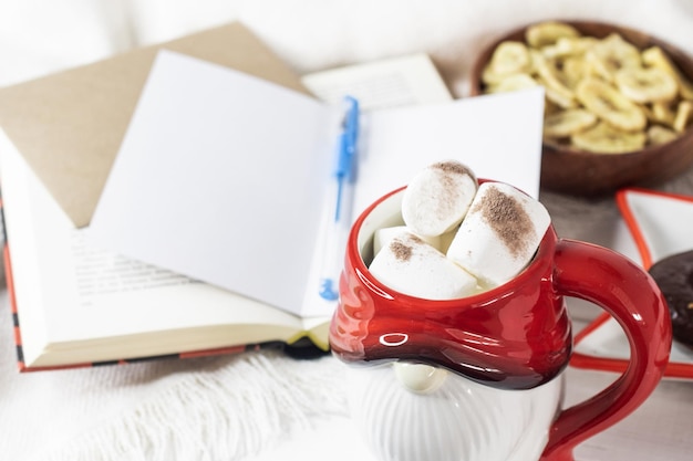 New Year's Eve background Santa Claus mug with marshmallows Christmas cookies open book