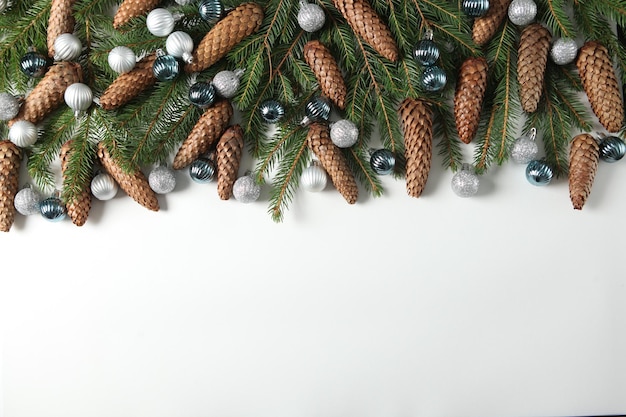 New Year's Eve background with fir branch and cones.