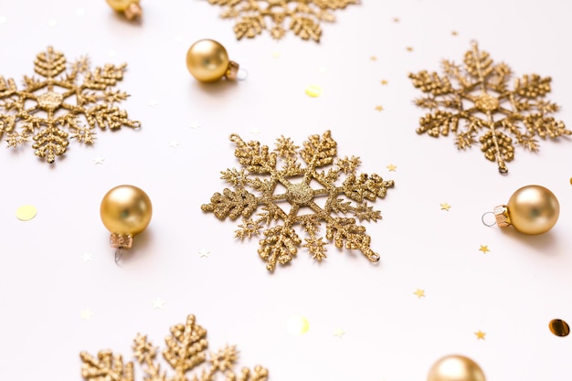 New Year's gold decorations, snowflakes and balloons on white background