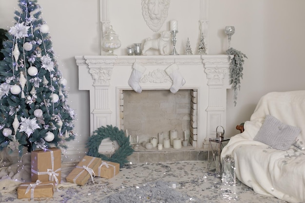 New Year's interior of the house with a fireplace in a light style