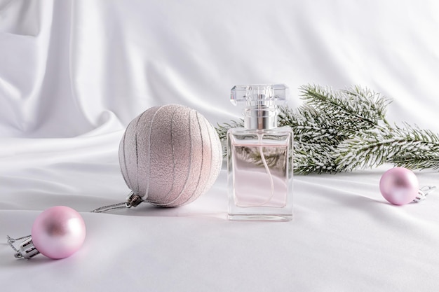 New Year's presentation and advertising of the female fragrance a chic bottle of perfume against the background of the Christmas decoration