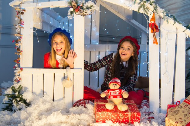 New year surprise. Happy children sit in house with xmas decoration. Little children with toy and Christmas gifts. Celebrating Boxing day. Boxing day is the day after Christmas. Have an enjoyable one.