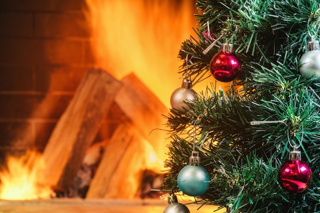 New year tree near cozy fireplace in country house