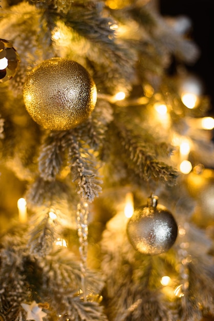 New Year Vertical Screensaver Closeup Round Toys Among Christmas Tree Branches and Garlands