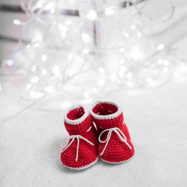 New year written laces of children's shoes and pacifier on old wooden background Toned image