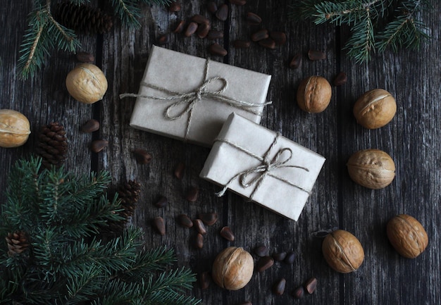 New Year39s layout of gifts spruce branches pine and walnuts on a wooden background