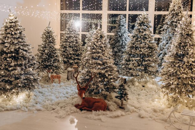 New Year39s photo zone with snow near a cafe bakery Christmas decor toys Christmas trees bench garland glowing light bulbs festive mood picture for postcard