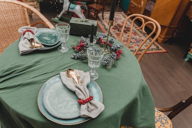 New Year39s table setting Christmas in the style of the new year39s fifties rustic antique style decorated apartment without food with plates candles and Christmas trees