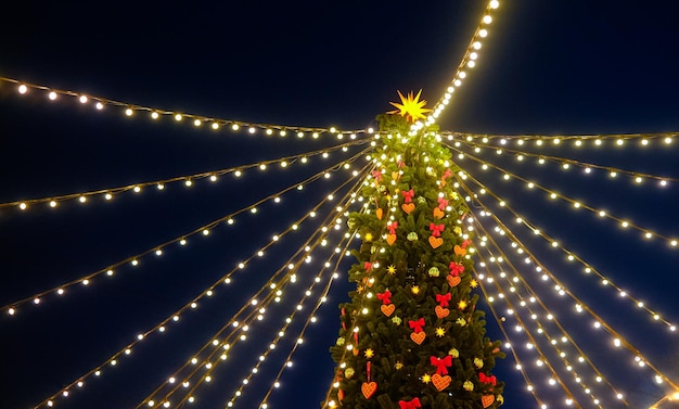 New Years celebration New Years fair in the city Christmas tree decorated with lights