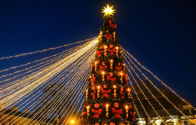 New Years celebration New Years fair in the city Christmas tree decorated with lights