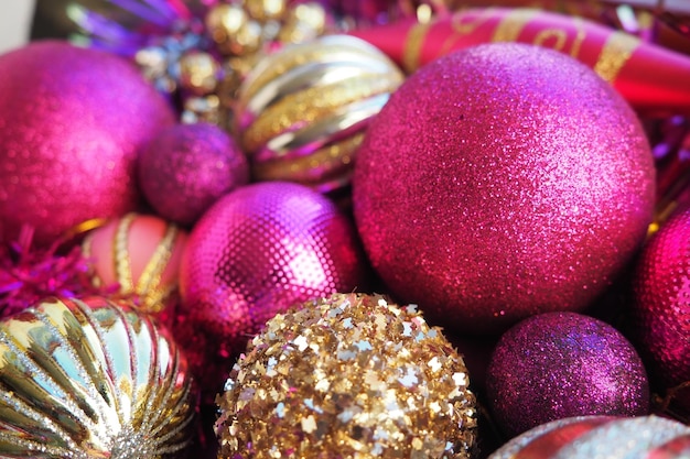 New years christmas balls tinsel and decorations close up decorations of golden pink lilac purple