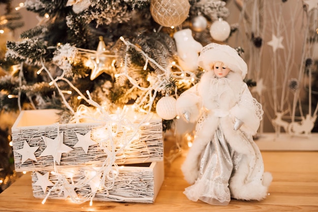 New Years decor is on a shelf next to glowing garlands