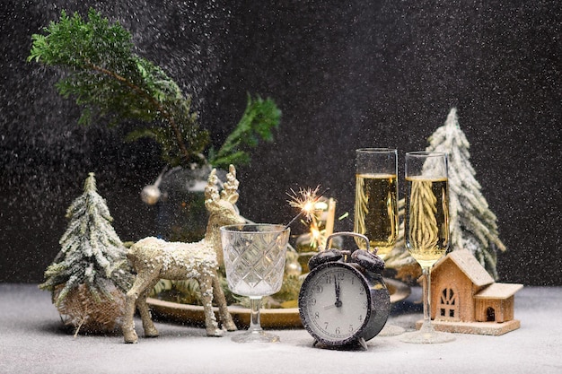 New years still life its almost  oclock at night champagne small decorative christmas trees high qua...