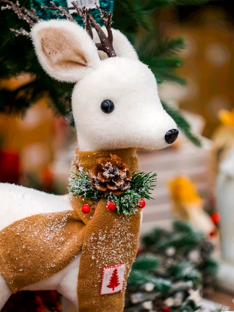 New Years white toy deer under an Artificial Christmas tree