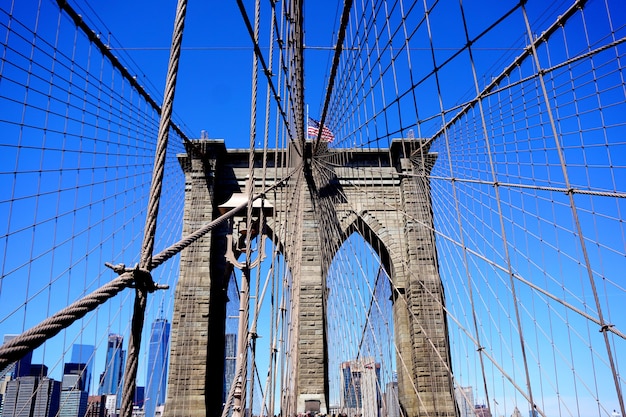 New York, USA. Close up of brownstone Brooklyn bridge. Manhattan skyline view from the bridge.