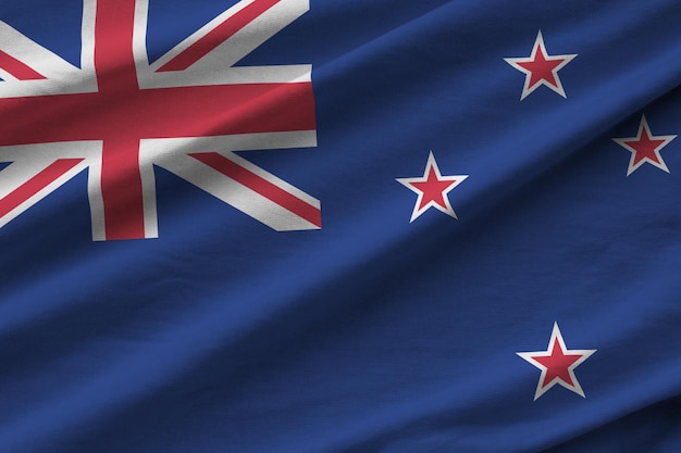 New Zealand flag with big folds waving close up under the studio light indoors The official symbols and colors in banner