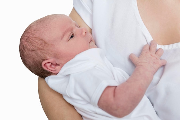 A newborn baby of the age of one week in the arms of his mother Love and tenderness Isolated on white background Closeup