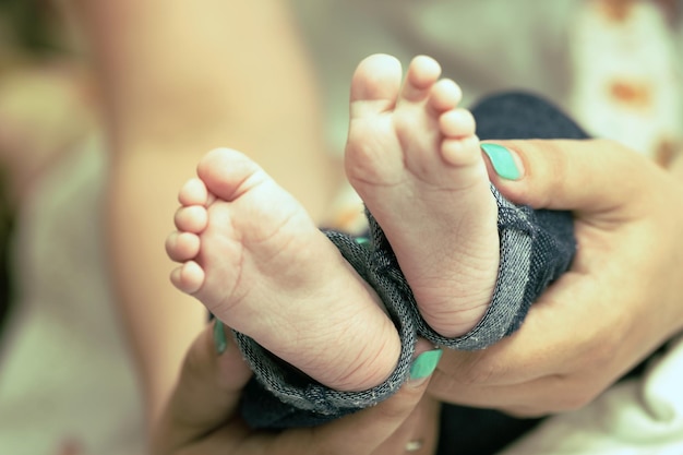 Newborn baby feet in mother's hands