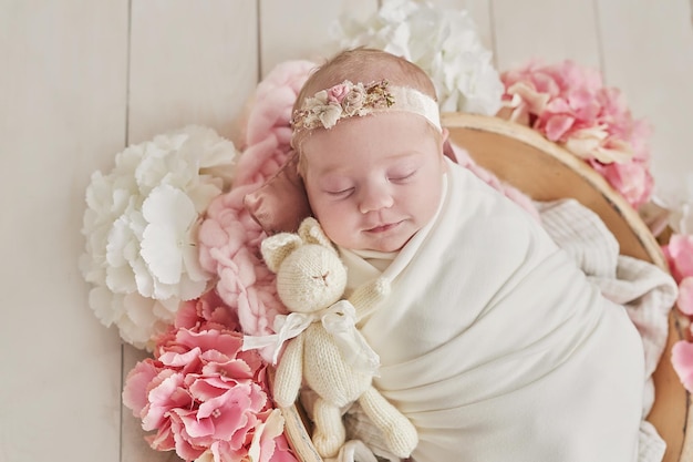 Newborn baby girl in flowers Healthy child Happy motherhood and parenting