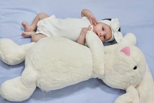 Newborn baby girl with her bunny