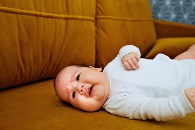 Newborn baby lies on the dewan newborn baby shows different emotions