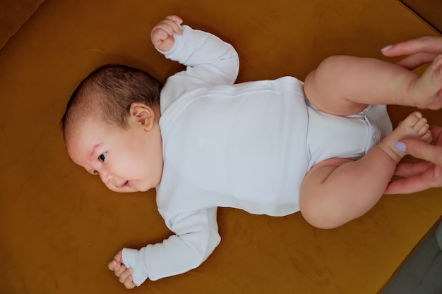 Newborn baby lies on the dewan newborn baby shows different emotions