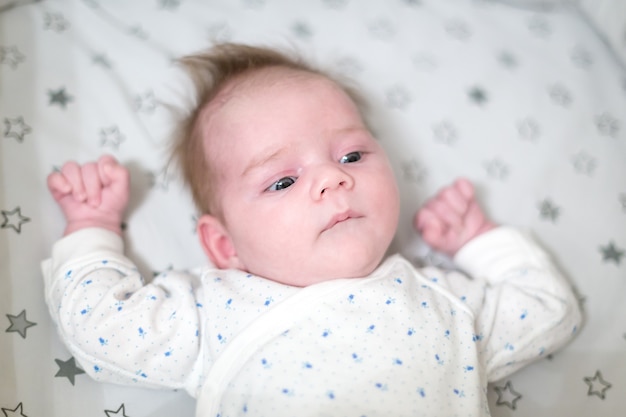 Newborn baby lying in a bad