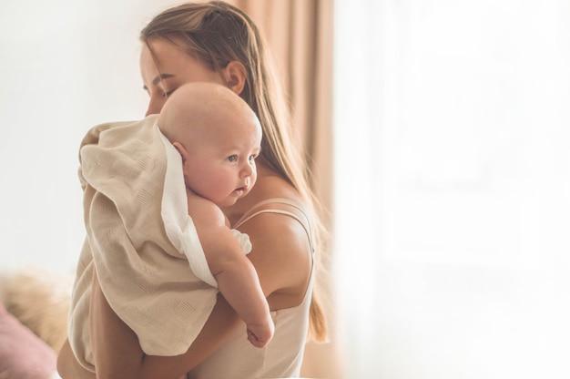 Newborn baby with mother on the bed