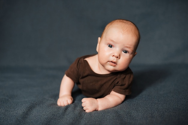 Newborn boy lying on a blanket. Caucasian little baby