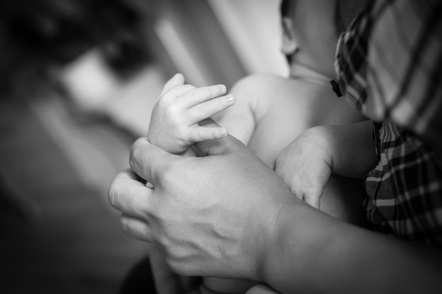 Newborn children's hand in mother hand.