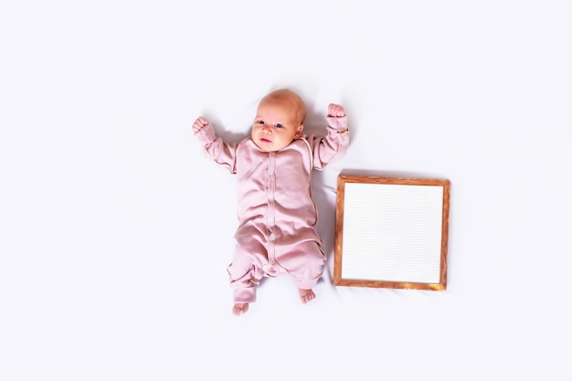 Newborn girl on white with text plate