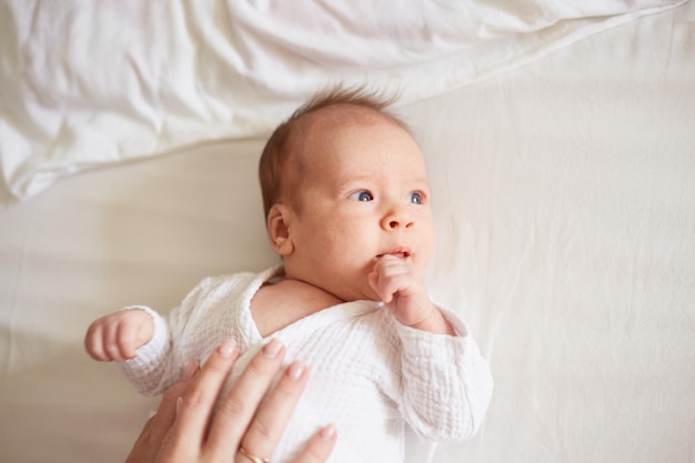 Newborn one month old baby boy smiling baby