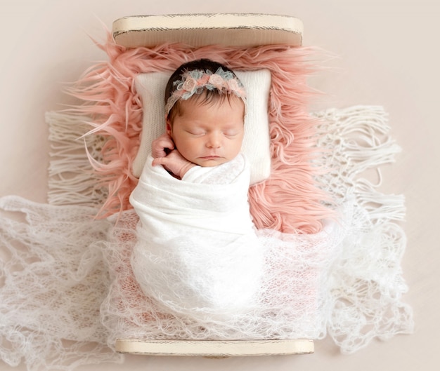 Newborn sleeping on baby bed