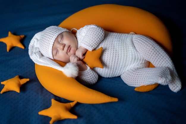 The newborn sleeps on the moon among the stars