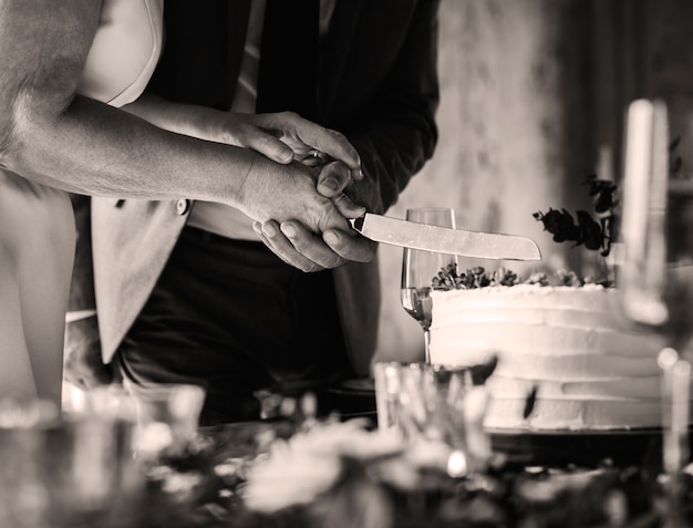 Newlywed Couple Hands Cutting Cake Together