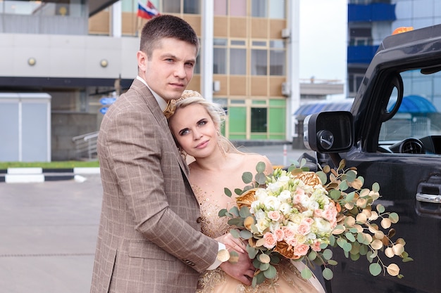 The newlyweds are walking around the city. The bride and groom are coming. Beautiful wedding