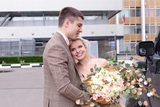 The newlyweds are walking around the city. The bride and groom are coming. Beautiful wedding