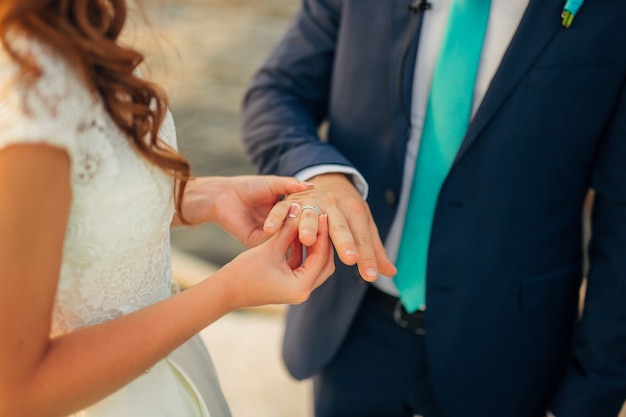 The newlyweds exchange rings at a wedding in Montenegro.