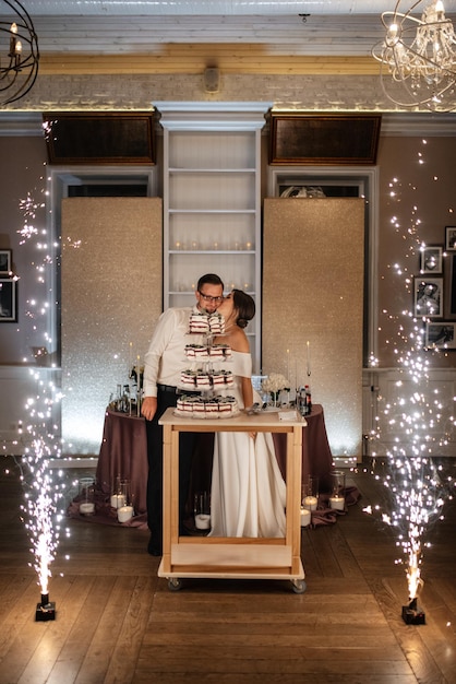 Newlyweds happily cut laugh and taste the wedding cake