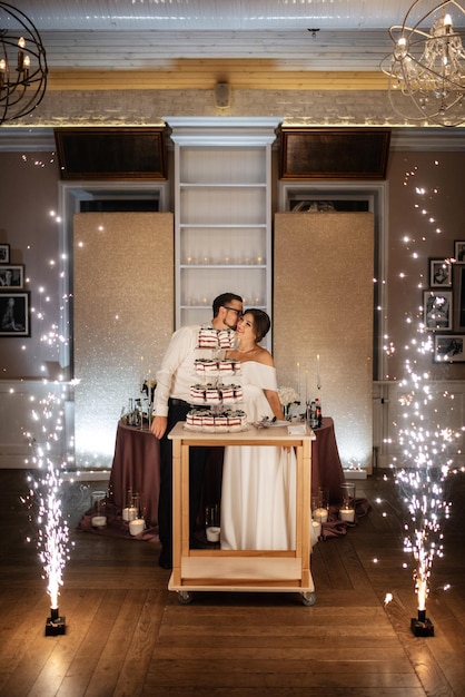 Newlyweds happily cut laugh and taste the wedding cake